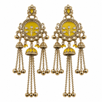 A pair of ornate gold-toned Indian jhumka earrings with bright yellow enamel panels, white faux pearl bead borders, and dangling chain bells on a plain white background.