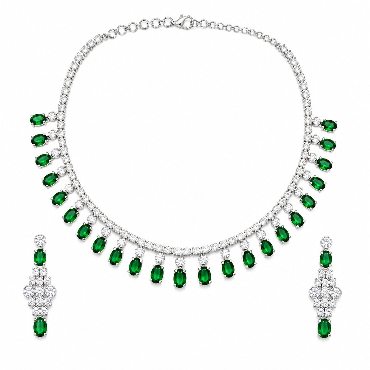 A silver-tone jewelry set featuring a necklace and matching drop earrings, both adorned with small clear stones and a row of oval-cut green emeralds, displayed on a solid white background.