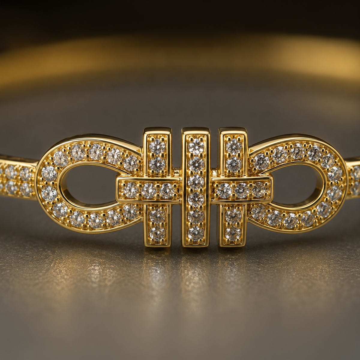 A gold-toned bracelet featuring a central interlocking bowtie-like motif paved with small clear stones, shown in a close-up studio shot on a dark reflective surface.