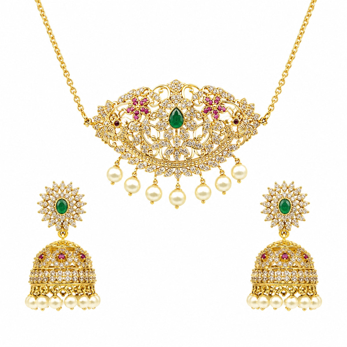Gold-plated Indian jewelry set featuring a necklace and matching earrings. The necklace has an ornate filigree pendant with a green emerald center, pink gemstone floral accents, and dangling white pearls.