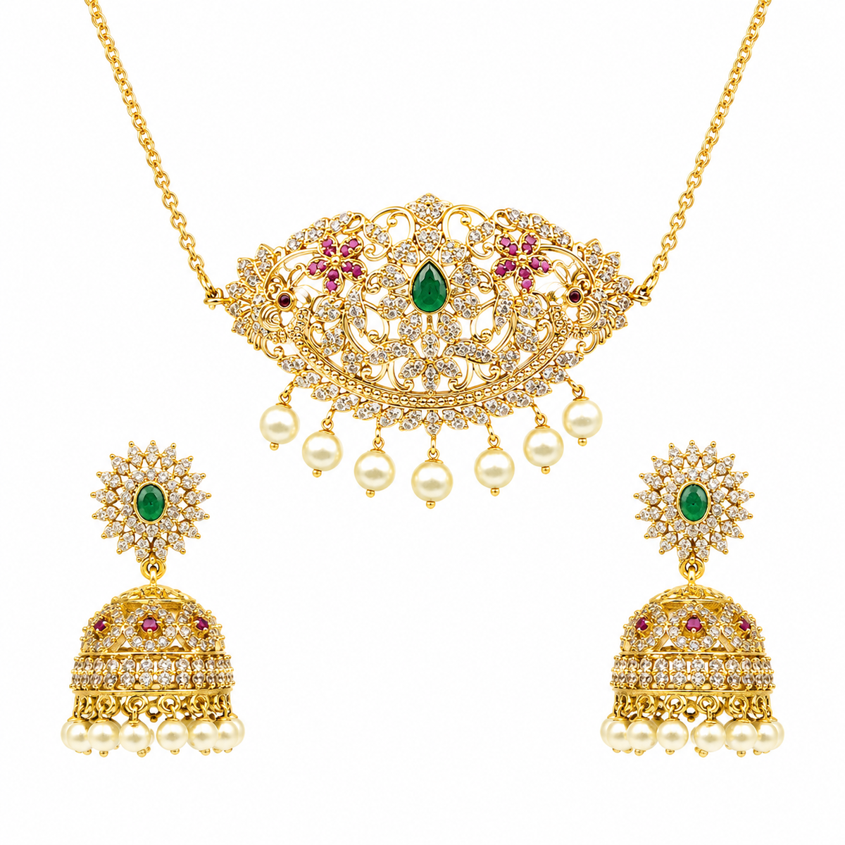 Gold-plated Indian jewelry set featuring a necklace and matching earrings. The necklace has an ornate filigree pendant with a central green emerald, pink gemstone accents, and dangling white faux pearls.