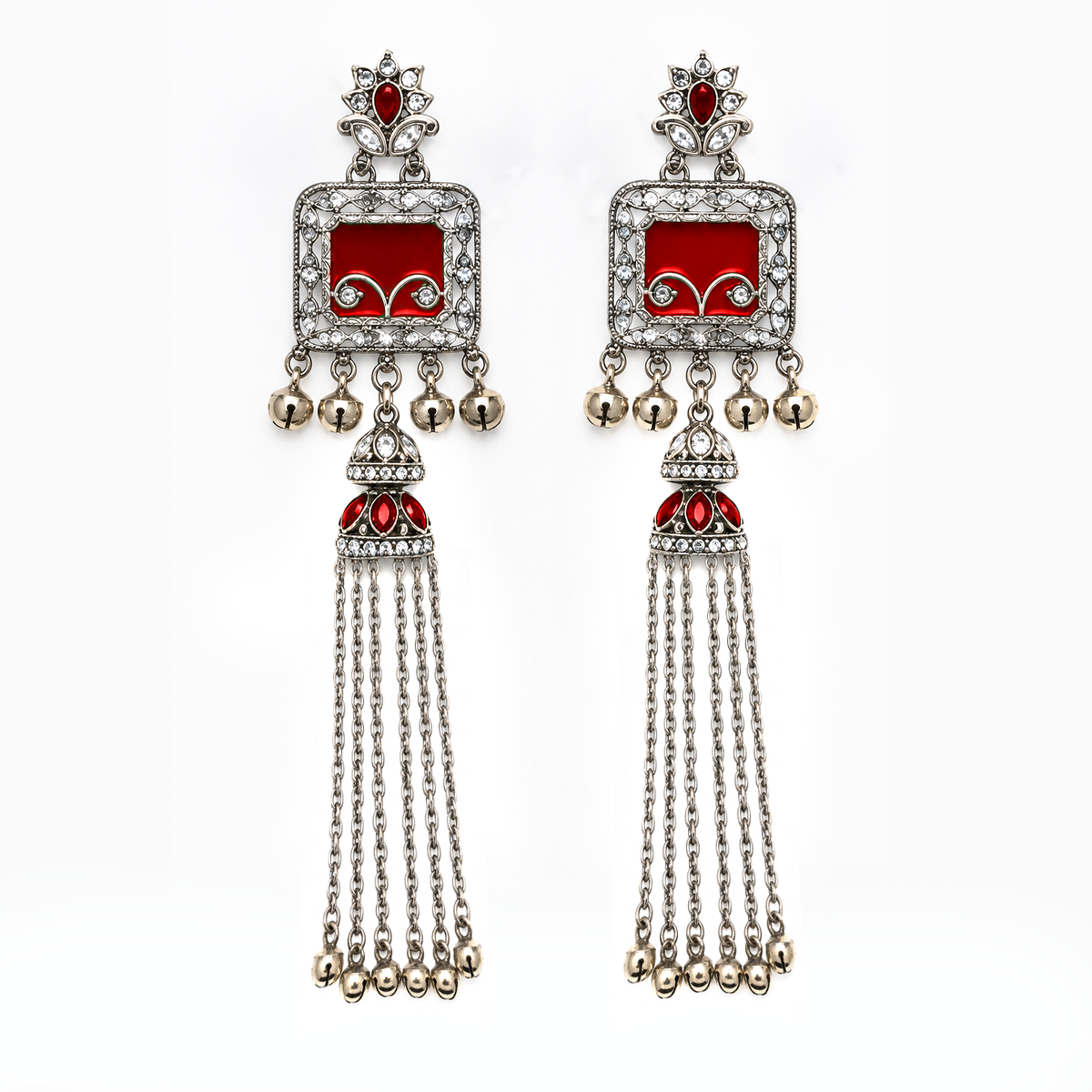 A pair of traditional Indian silver-toned dangle earrings with red enamel panels, clear pavé stones, and dangling silver bells, shown on a plain white background.