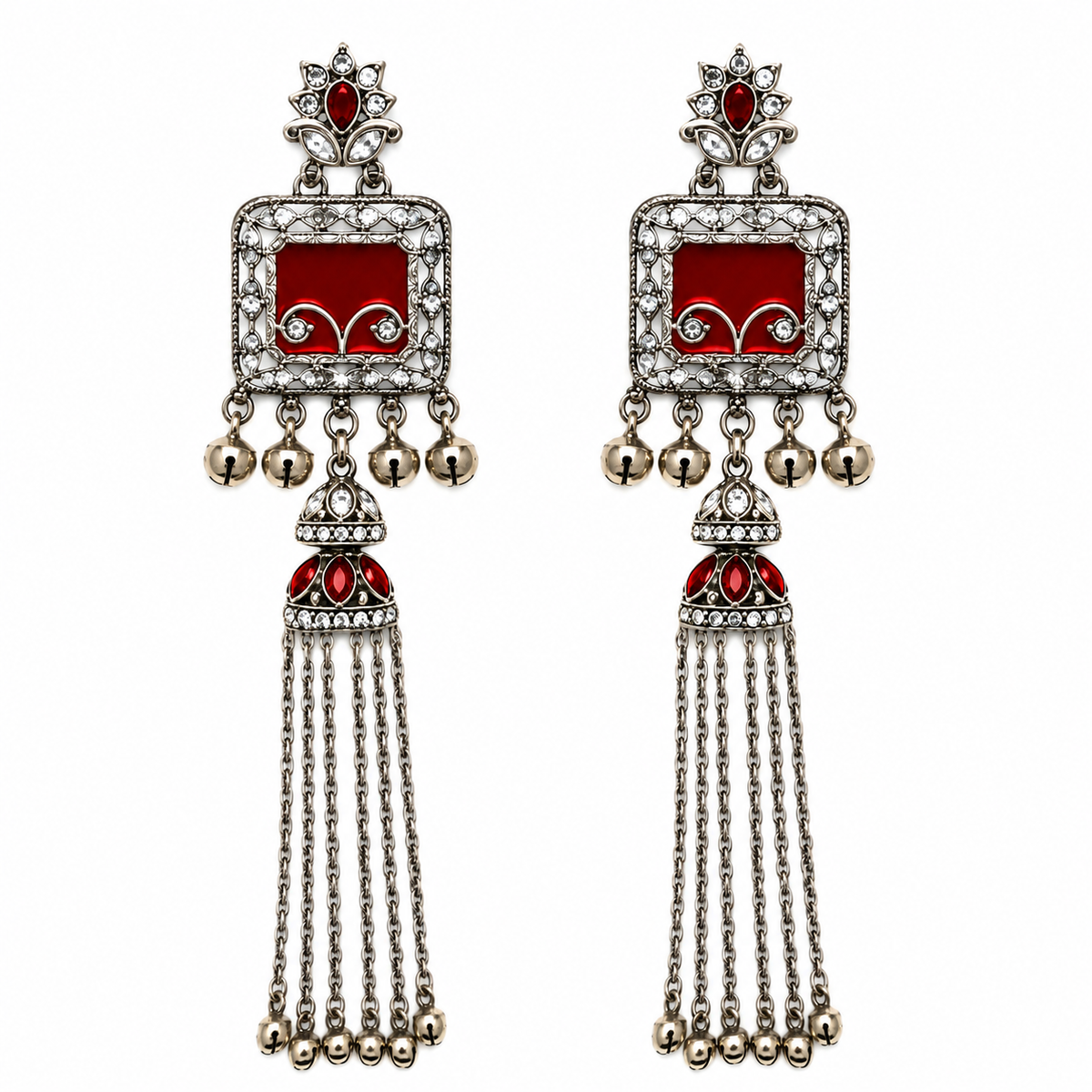 A pair of traditional Indian silver-toned tassel earrings with red enamel panels, clear rhinestones, and small hanging bells, shown on a plain white background.