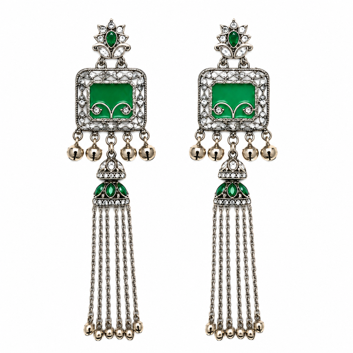 A pair of traditional Indian silver-toned dangle earrings with green enamel panels, clear pavé stones, and dangling gold-tone bells.