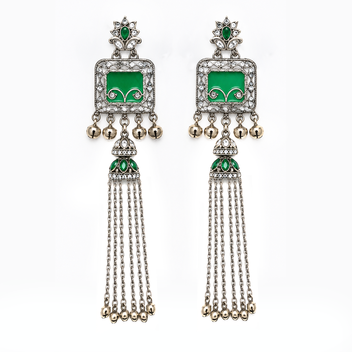 A pair of traditional Indian silver-toned dangle earrings with green enamel inlays, clear pavé stones, and dangling silver bells, shown against a plain white background.