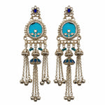 A pair of traditional Indian silver-toned dangle earrings with turquoise blue enamel inlays, small blue stone accents, and dangling chain bells, shown against a plain white background.
