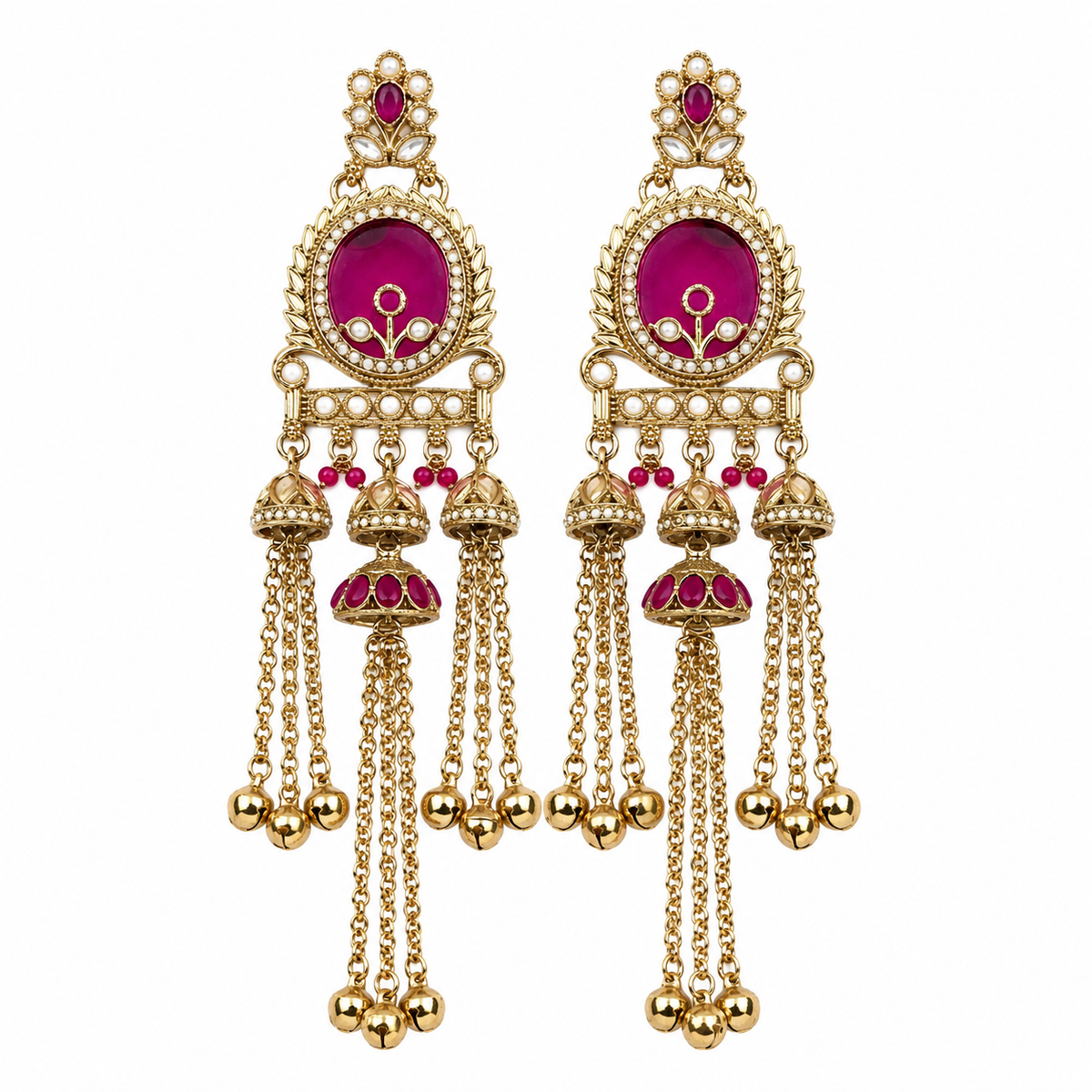 A pair of ornate gold-toned Indian jhumka earrings with vibrant magenta-pink enamel inlays and small red stones, shown on a plain white background.