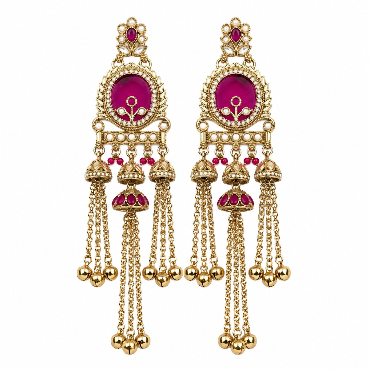 A pair of ornate gold-toned Indian jhumka earrings with vibrant magenta pink enamel details and small red stones, shown against a plain white background.