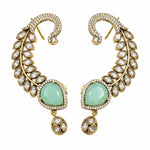 A pair of gold crescent-shaped drop earrings decorated with clear marquise and round crystals, featuring a large light green teardrop-shaped center stone on each earring.