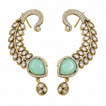 A pair of gold-plated crescent-shaped drop earrings adorned with clear pavé stones and light green teardrop-shaped cabochons, set against a plain white background.