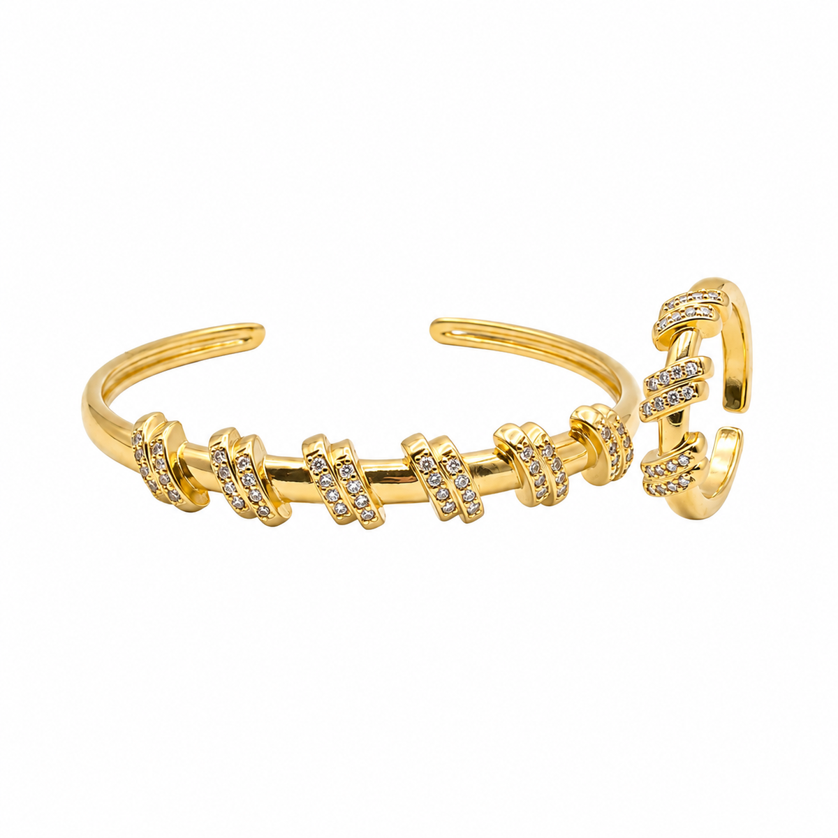 A gold-toned open cuff bracelet featuring multiple textured disc links embellished with small clear stones, shown on a plain white background.