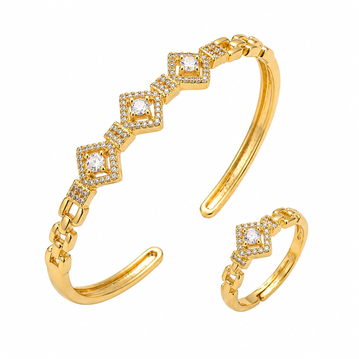 Gold-toned open cuff bracelet and matching ring set, each featuring a row of diamond-shaped clear gemstones set in a halo of small crystals, shown on a plain white background.