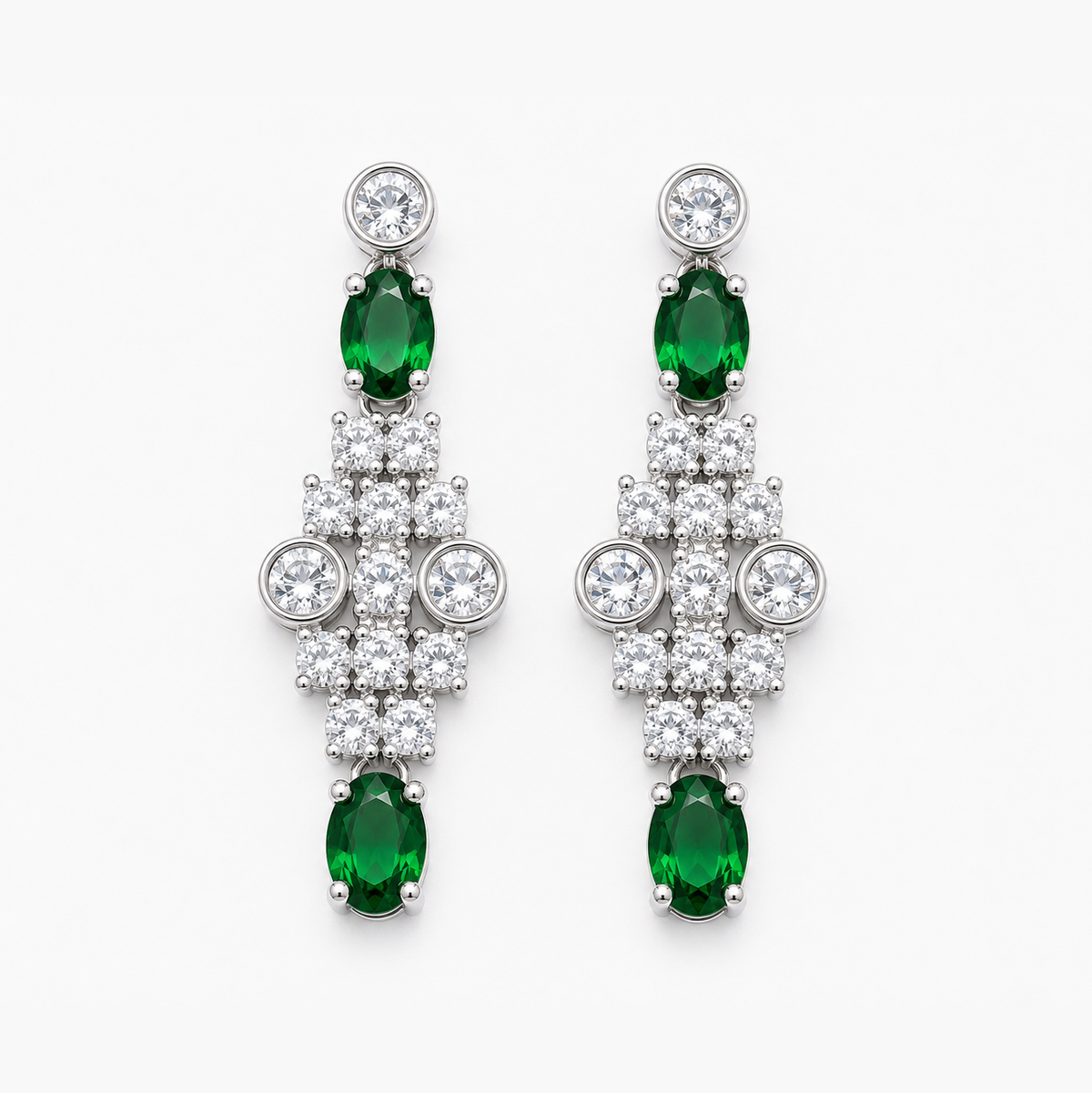 A pair of silver-tone drop earrings featuring oval-cut emerald-cut green gemstones and clusters of round clear stones, shown against a plain white background.