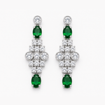 A pair of silver-tone drop earrings featuring oval-cut emerald-cut green gemstones and clusters of round clear stones, shown against a plain white background.