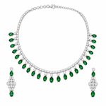 A silver-tone jewelry set featuring a necklace and matching drop earrings, both adorned with rows of clear stones and a series of oval-cut green emerald-shaped gems hanging along the front.