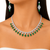 A close-up of a model's neck and shoulders wearing a silver-toned necklace with marquise-cut green emeralds and matching drop earrings with emeralds and clear stones.