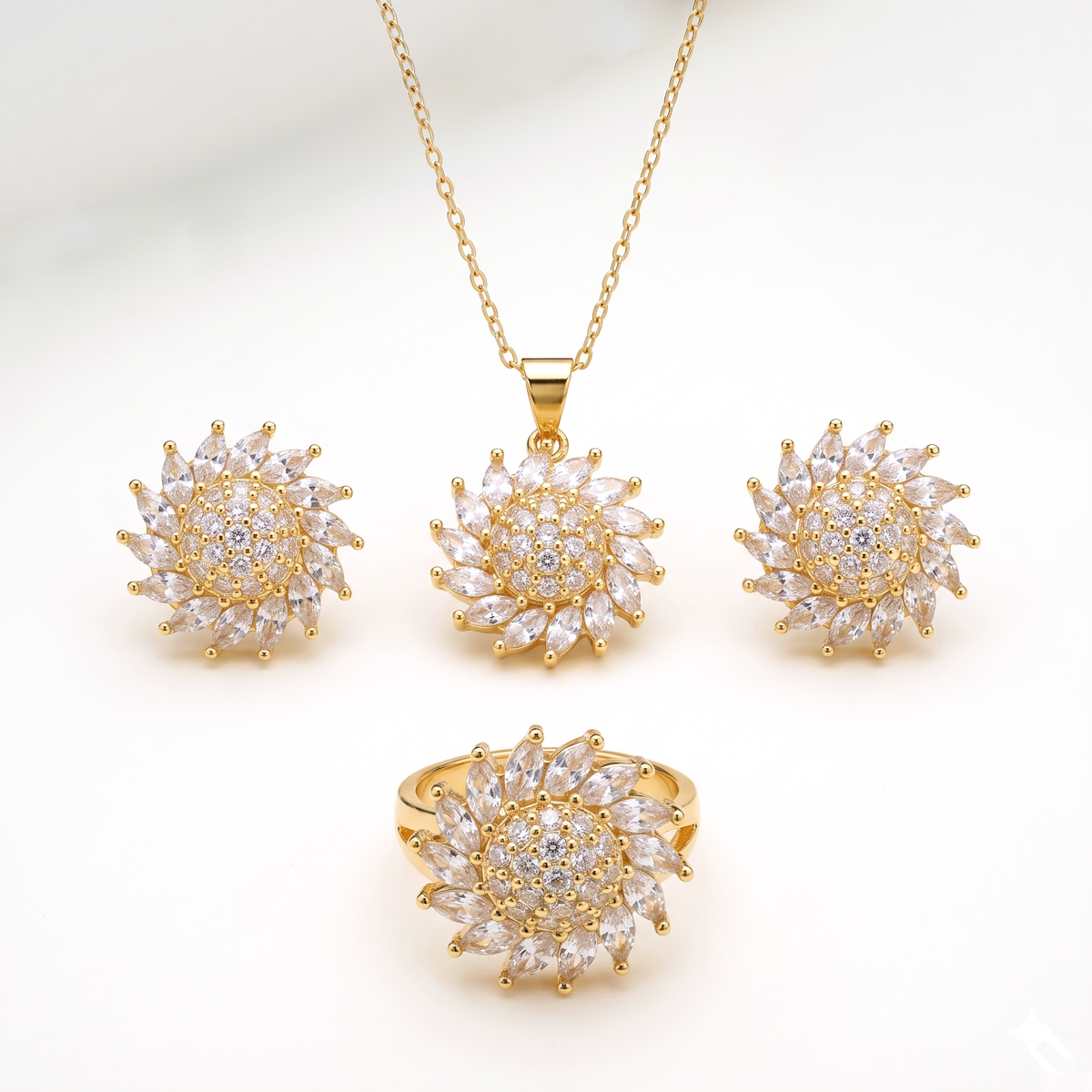 A gold jewelry set featuring a necklace, ring, and two matching earrings, all designed with a sunflower-like cluster of clear marquise-cut stones on a white background.