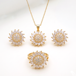 A gold jewelry set featuring a necklace, ring, and two matching earrings, all designed with a sunflower-like cluster of clear marquise-cut stones on a white background.