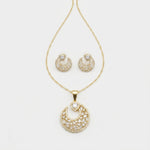 Gold crescent moon jewelry set featuring a pendant necklace and matching stud earrings, embellished with clear pavé stones on a white background.